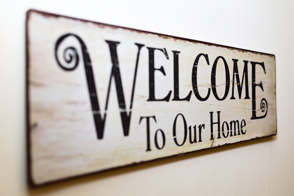 Distressed sign that says "Welcome To Our Home." Suggestion that at the end of the home buying process, the buyer can hang this in their new home.